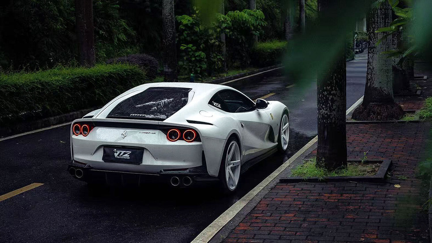 Rear view of Ferrari 812 on forest road with Klutch K1001 forged wheels